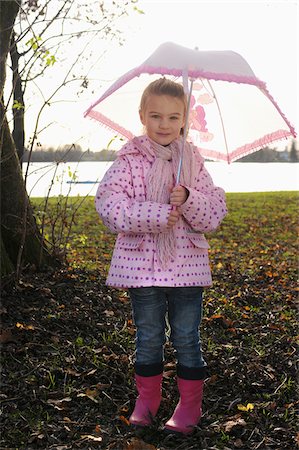 rubber boots in little girl - Girl holding Umbrella Stock Photo - Premium Royalty-Free, Code: 600-03738701