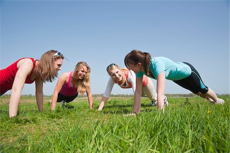 exercising with friend - Young Women Doing Push-Ups Stock Photo - Premium Royalty-Free, Code: 600-03814765