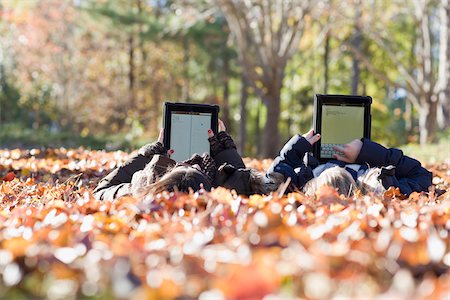 Girls using iPads in Autumn Stock Photo - Premium Royalty-Free, Code: 600-03848749