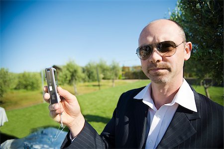 pictures of bald men in glasses - Man taking Pictures at Wedding Stock Photo - Premium Royalty-Free, Code: 600-03849297