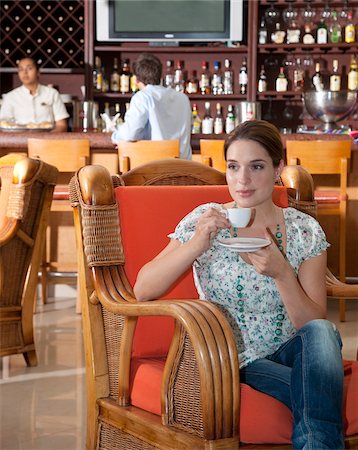 Woman Drinking Coffee in Restaurant Stock Photo - Premium Royalty-Free, Code: 600-03849577