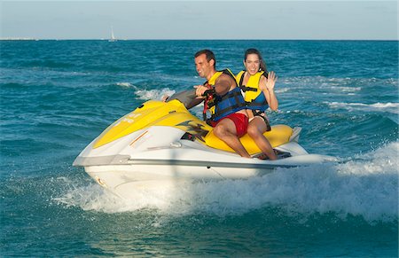 Couple on Personal Watercraft Stock Photo - Premium Royalty-Free, Code: 600-03849570