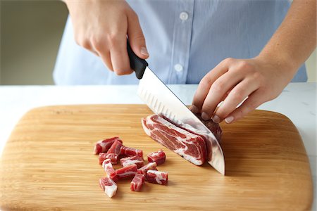 pork chop - Woman Chopping Pancetta into Cubes Stock Photo - Premium Royalty-Free, Code: 600-03849748