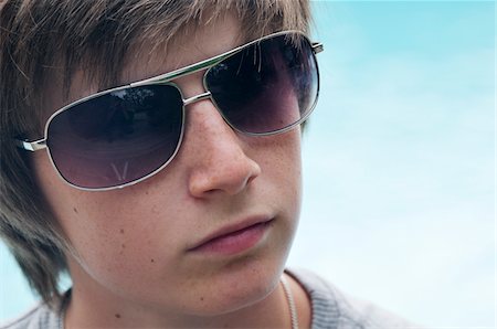 preteens face pictures - Portrait of Boy wearing Sunglasses Stock Photo - Premium Royalty-Free, Code: 600-03865127