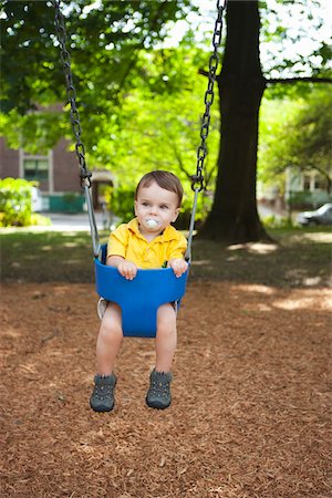 simsearch:600-05653250,k - Boy Playing on Swings, Washington Park Playground, Portland, Oregon, USA Stock Photo - Premium Royalty-Free, Code: 600-03865183