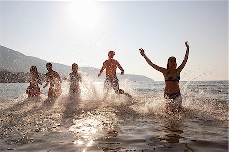 Young friends splashing in the sea Stock Photo - Premium Royalty-Free, Code: 614-05399412