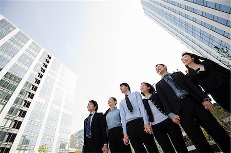 six people holding hands - Businesspeople in a row in city scene Stock Photo - Premium Royalty-Free, Code: 614-05399802