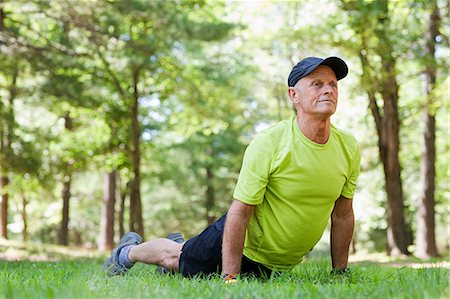 exercise senior man - Man stretching on grass Stock Photo - Premium Royalty-Free, Code: 614-05522987