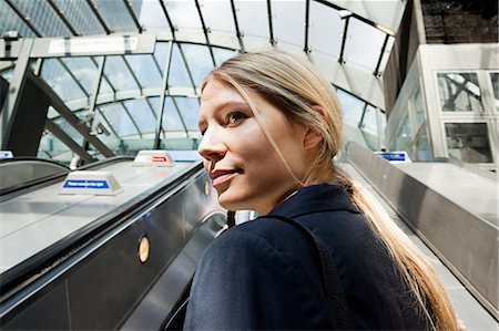Businesswoman on subway escalators Stock Photo - Premium Royalty-Free, Code: 614-05556693