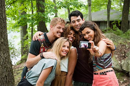 Friends posing in front of digital camera Stock Photo - Premium Royalty-Free, Code: 614-05556843