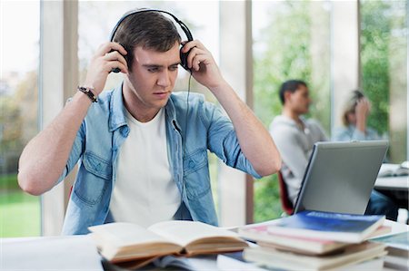 student (male) - University student putting on headphones Stock Photo - Premium Royalty-Free, Code: 614-05557309