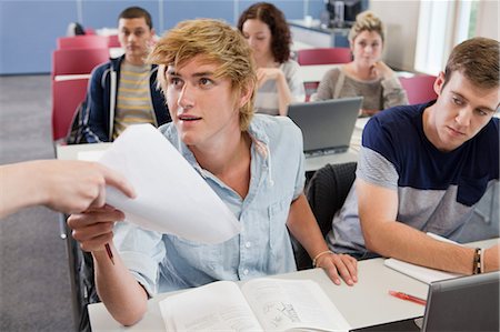 University student receiving exam paper Stock Photo - Premium Royalty-Free, Code: 614-05557322