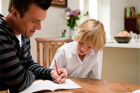 Father helping son with his homework Stock Photo - Premium Royalty-Free, Code: 614-05650649