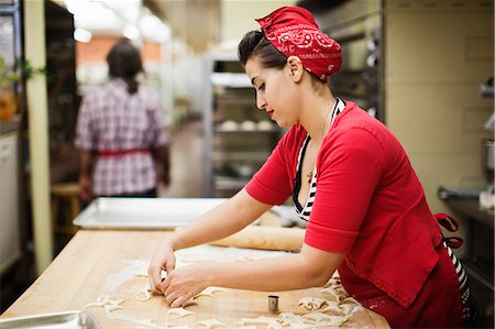 Young baker preparing food in kitchen Stock Photo - Premium Royalty-Free, Code: 614-05662169