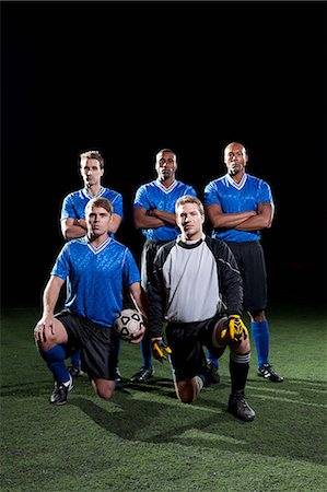 Soccer team on pitch at night Stock Photo - Premium Royalty-Free, Code: 614-05792061