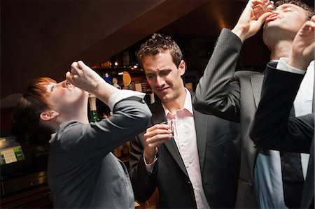 drunken - Businesspeople drinking at a bar Stock Photo - Premium Royalty-Free, Code: 614-05792417