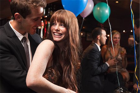 Happy young couple at party Stock Photo - Premium Royalty-Free, Code: 614-05792421