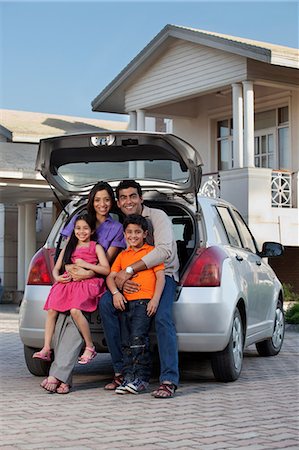 east indian mother and children - Family sitting at the back of a car Stock Photo - Premium Royalty-Free, Code: 614-05955306