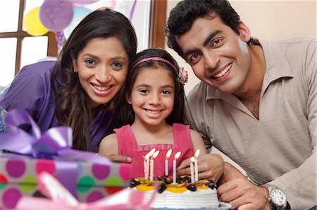 east indian mother and children - Girl celebrating her birthday with parents Stock Photo - Premium Royalty-Free, Code: 614-05955301