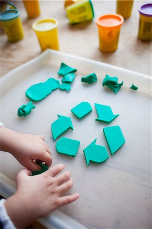 symbol for intelligence - Child making recycling symbol from play clay Stock Photo - Premium Royalty-Free, Code: 614-05955440