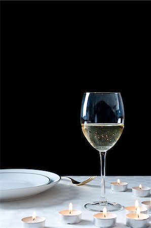 simsearch:614-06002054,k - Glass of white wine and tea lights on table Stock Photo - Premium Royalty-Free, Code: 614-06002043