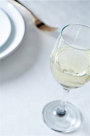 simsearch:614-06002054,k - Glass of white wine on table Stock Photo - Premium Royalty-Free, Code: 614-06002079