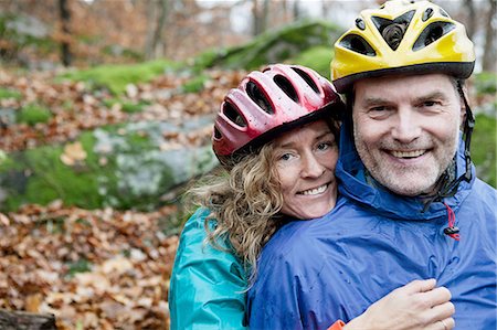 Portrait of mature couple wearing cycling helmets in forest Stock Photo - Premium Royalty-Free, Code: 614-06002102