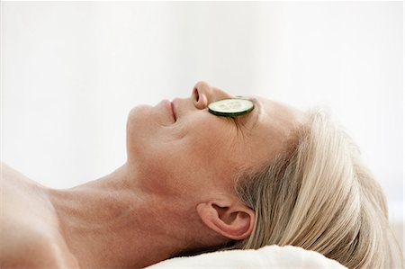 spa treatment - Mature woman relaxing with cucumber slices over eyes Stock Photo - Premium Royalty-Free, Code: 614-06002290