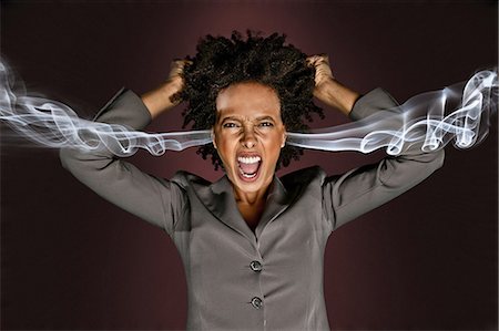 pressure - Frustrated woman with smoke coming from ears Stock Photo - Premium Royalty-Free, Code: 614-06044004