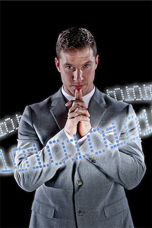 future technology - Businessman surrounded by ring of binary code Stock Photo - Premium Royalty-Free, Code: 614-06044003
