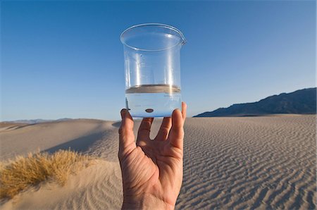 Man holding water in beaker in Death Valley National Park, California, USA Stock Photo - Premium Royalty-Free, Code: 614-06044078