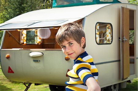 Boy outside caravan, portrait Stock Photo - Premium Royalty-Free, Code: 614-06044073