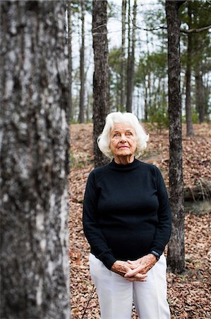 Portrait of senior woman in forest, hands clasped Stock Photo - Premium Royalty-Free, Code: 614-06044101