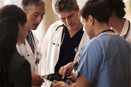 doctor tablet - Doctors discussing patients charts on digital tablet in hospital Stock Photo - Premium Royalty-Free, Code: 614-06044383