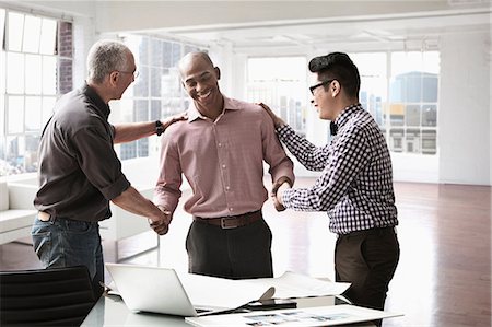 Businessmen congratulating colleague Stock Photo - Premium Royalty-Free, Code: 614-06043785