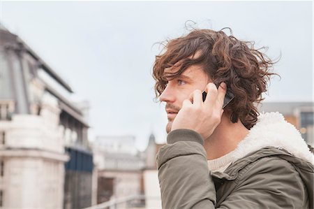 Young man on cell phone Stock Photo - Premium Royalty-Free, Code: 614-06043945