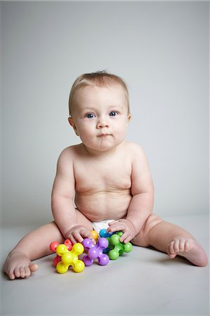 Baby boy playing with jacks Stock Photo - Premium Royalty-Free, Code: 614-06043989