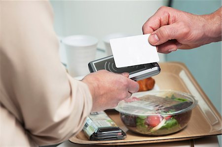 people holding cards in hand - Man using card to buy food Stock Photo - Premium Royalty-Free, Code: 614-06116012