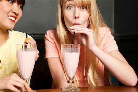 sucking - Two women drinking milkshake Stock Photo - Premium Royalty-Free, Code: 614-06168754