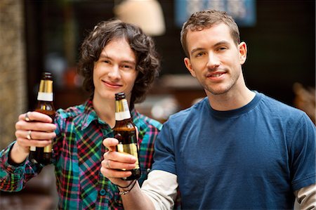 Male friends posing with beer bottles Stock Photo - Premium Royalty-Free, Code: 614-06168770