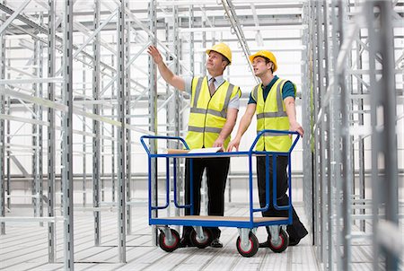 Two men in empty warehouse with trolley Stock Photo - Premium Royalty-Free, Code: 614-06168824