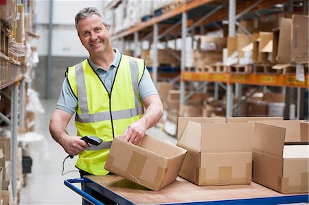 pack - Man using barcode reader in warehouse Stock Photo - Premium Royalty-Free, Code: 614-06168851