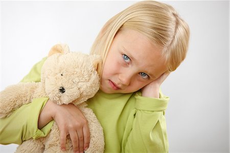 sad child indoors - Girl with teddy covering ears Stock Photo - Premium Royalty-Free, Code: 614-06168880