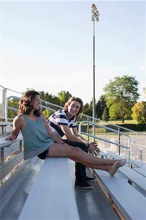 Teenage couple sitting on bleachers Stock Photo - Premium Royalty-Free, Code: 614-06169090