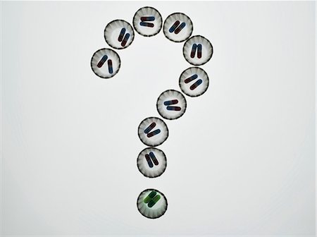 questions - Dispenser cups of pills forming a question mark Stock Photo - Premium Royalty-Free, Code: 614-06169234