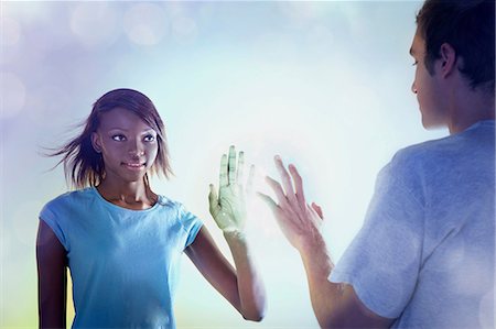 future technology - Young people touching light Stock Photo - Premium Royalty-Free, Code: 614-06169357