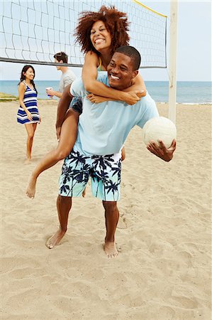 fitness asian couple - Couple on beach with volleyball, man giving woman piggyback Stock Photo - Premium Royalty-Free, Code: 614-06169364