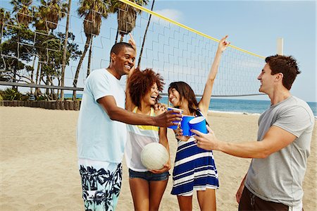 Friends on beach with volleyball and net Stock Photo - Premium Royalty-Free, Code: 614-06169365