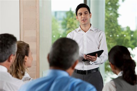 Man using digital tablet in business meeting Stock Photo - Premium Royalty-Free, Code: 614-06311661