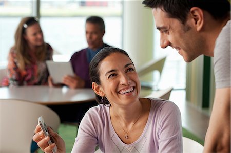 Woman showing man smartphone Stock Photo - Premium Royalty-Free, Code: 614-06311686